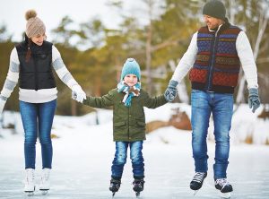 Family skating on a pond wearing Kemimoto heated clothing.